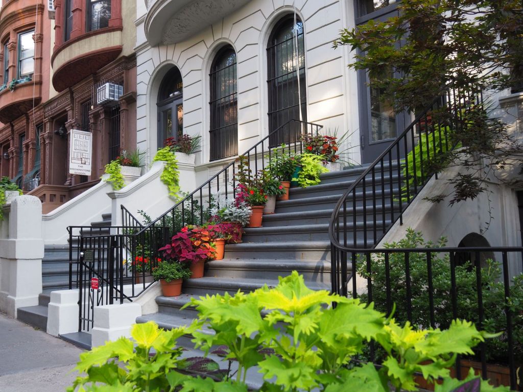 Plants cascade down the steps of a stoop on the Upper West Side of Manhattan, New York